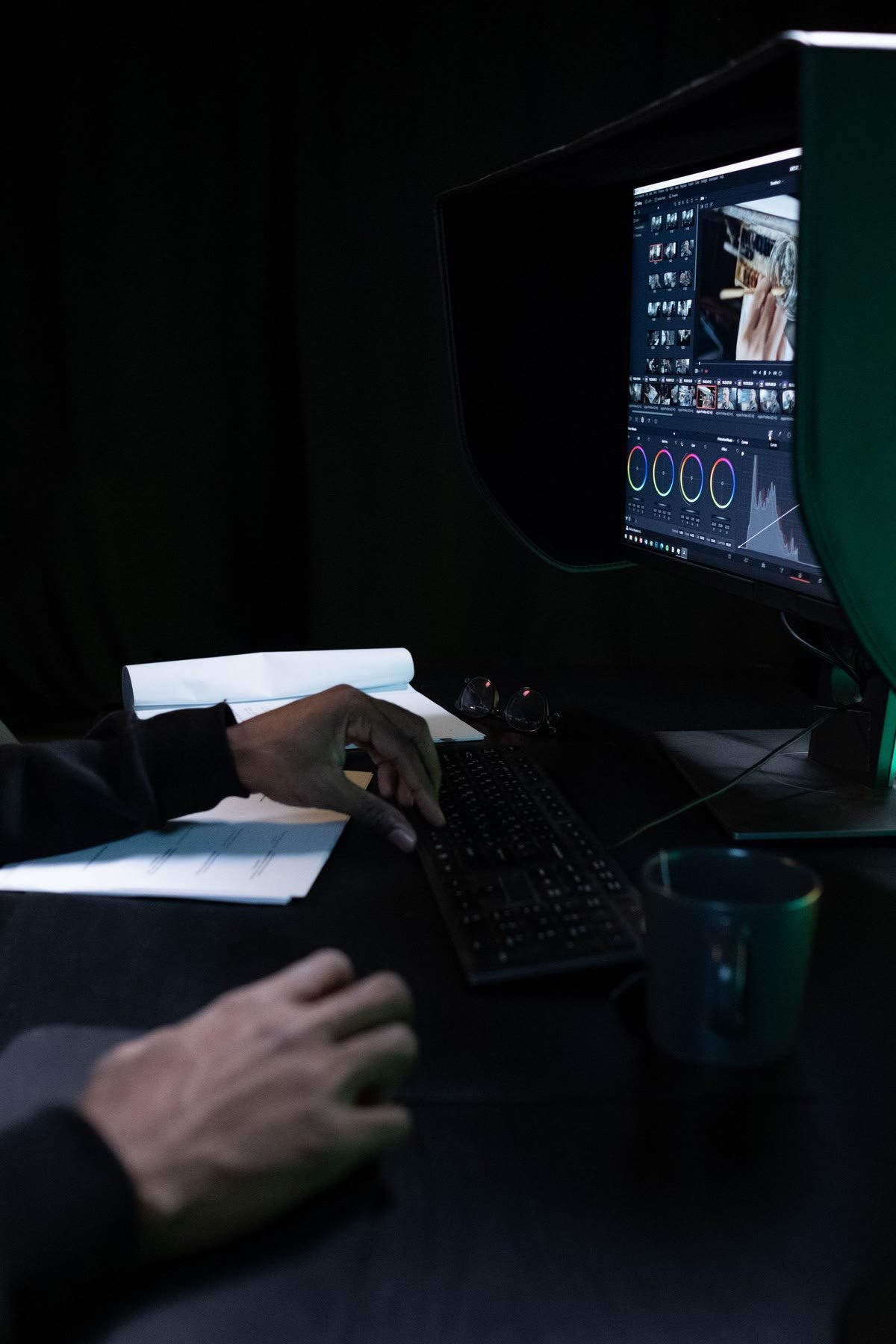 A colourist grading footage on a calibrated studio monitor